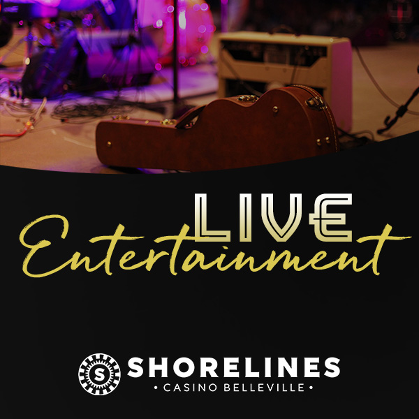 Shorelines Casinos Belleville - Live Entertainment - close up of an acoustic guitar case resting on a stage with an amp and drum set blurred in the background.